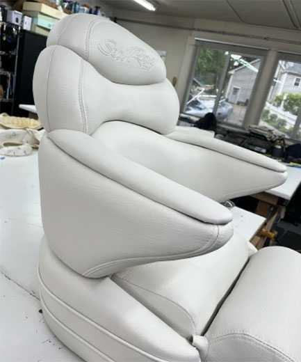 white reupholstered boat chair