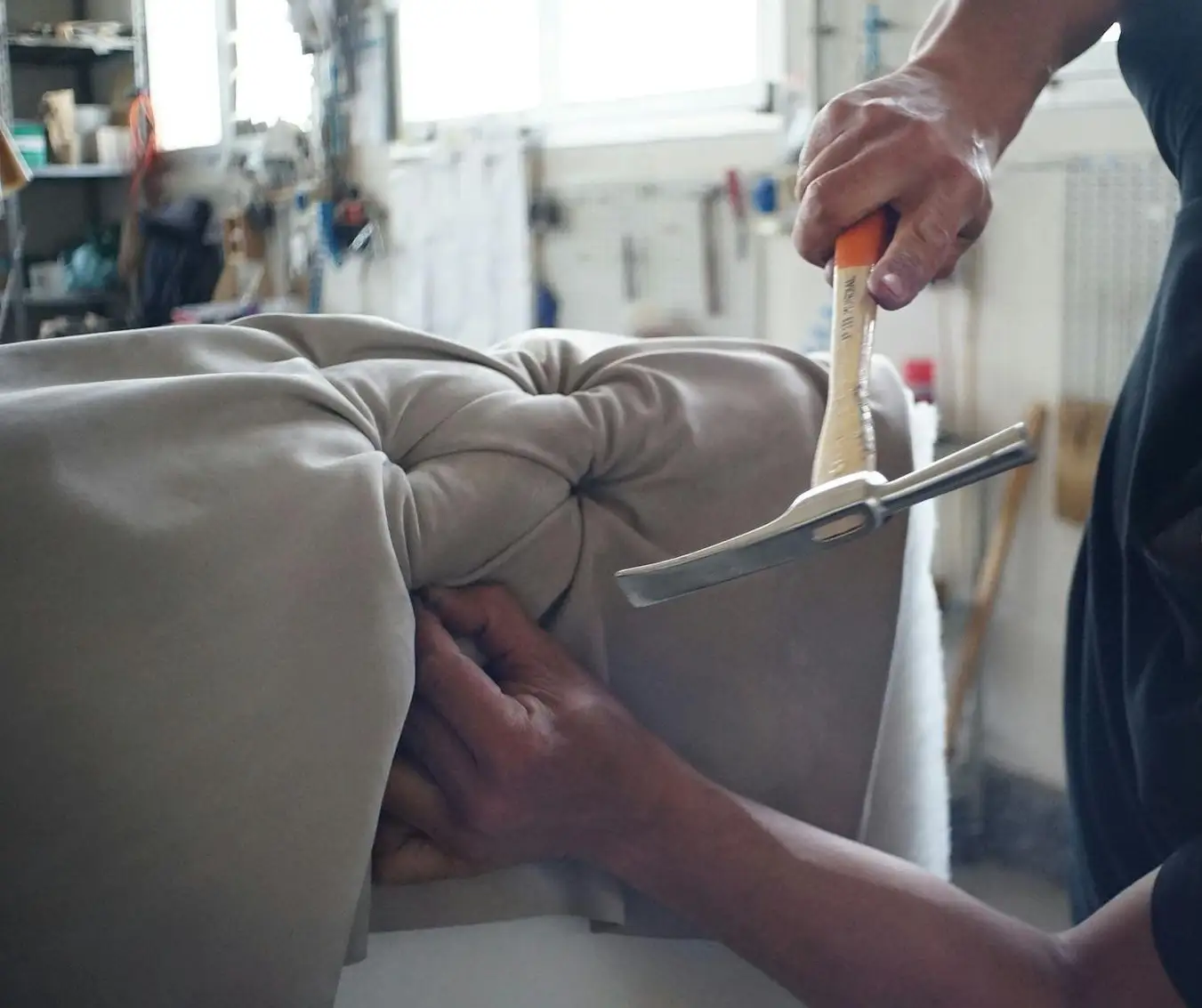 worker repairing sofa